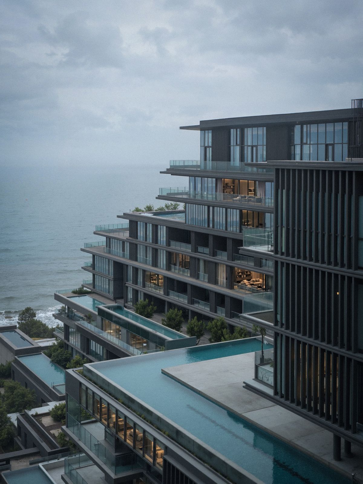 Edifício contemporâneo de terraços com piscina voltada ao mar